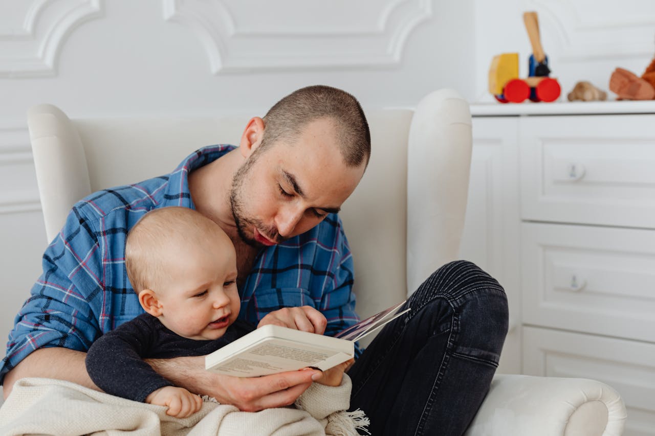 The Art of Drawing Readers In: Your attractive post title goes here A father and his baby enjoy a bonding moment while reading together indoors.